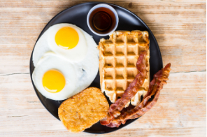 American breakfast with pancakes, eggs, bacon and hash browns